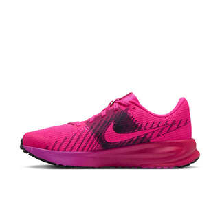 Women's pink running shoe side profile with black Swoosh and flexible ribbed upper