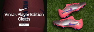 Nike Vini Jr. Player Edition cleats on grass with Nike logo and text.