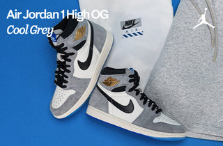 Air Jordan 1 High OG Cool Grey sneakers on a blue background with Nike and Jordan branding.