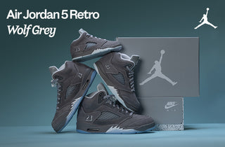 Air Jordan 5 Retro Wolf Grey sneakers with packaging on a blue background