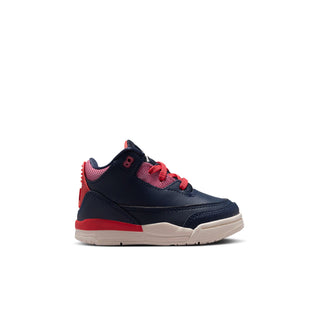 Toddler sneaker in dark navy with red laces, beige midsole, and blue accents