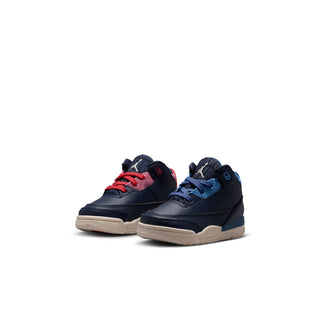 Pair of toddler sneakers: navy uppers with red and blue laces, beige soles
