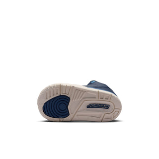 Toddler sneaker outsole view with navy-and-beige traction tread and Jordan logo