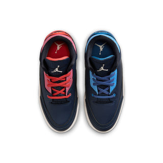 Kids sneakers showing two uppers: navy with red laces and navy with blue laces