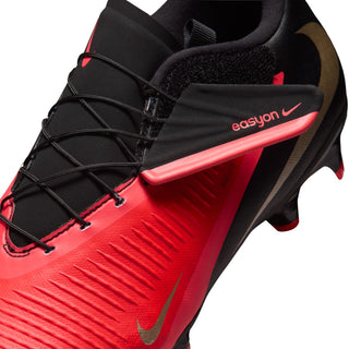 Close-up of men's lace-up FG cleat with black upper, bright red side panel