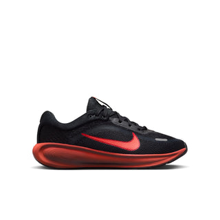 Youth Stellar Ride running shoe in black with a red swoosh and sculpted red sole.