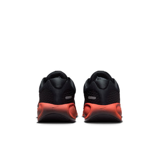 Rear view of black youth running shoes with sculpted red heel soles.