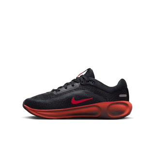 Side view of black youth running shoe with red swoosh and sculpted red sole.
