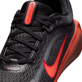 Close-up of black mesh shoe upper, red swoosh, laces, and tongue label.