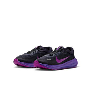 Pair of youth running shoes with dark mesh uppers and vivid purple accents
