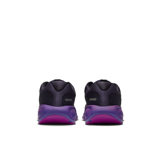 Pair of youth running shoes viewed from the heel, with sculpted purple soles