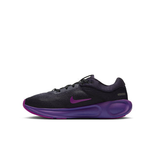 Youth running shoe side view with dark mesh upper, small purple swoosh, and thick purple sole