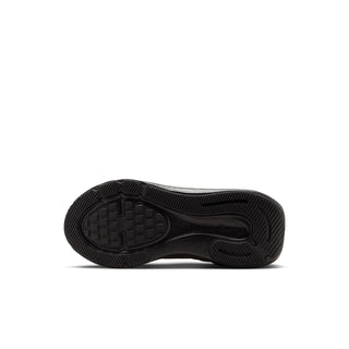 Outsole of a black kids' Nike running shoe with textured traction pattern