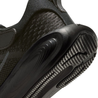 Close-up of black kids' Nike shoe showing textured mesh and ridged rubber outsole