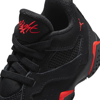 Black toddler sneaker close-up with red logo on the tongue and side