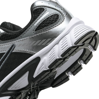 Kids Nike sneaker side close-up, silver-gray finish with black tread details