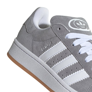 Youth Adidas Campus sneaker close-up: grey suede, white stripes, lace detail