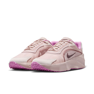 Light pink women’s running sneakers with purple inner lining and front Nike swoosh