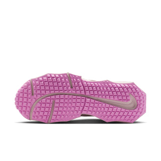 Purple rubber outsole with tread pattern and Nike swoosh for women’s running sneakers