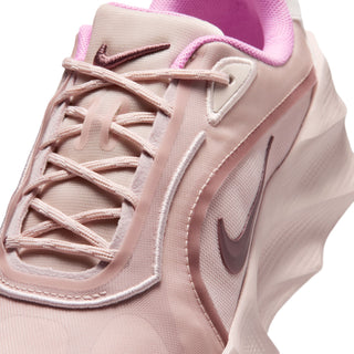 Close-up of light pink lace-up upper with stitched overlays and Nike swoosh