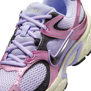 Women’s shoe close-up with lavender mesh, pink trim, and gray Nike Swoosh on side