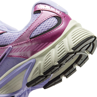 Women’s shoe close-up of side panel and heel with purple-pink strap and textured sole