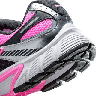 Women's sneaker outsole close-up, textured tread with pink midsole accent and gray upper.