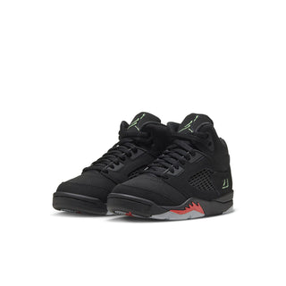 Black kids sneakers, pair view with lace-up design, mesh upper, green logo and red sole detail
