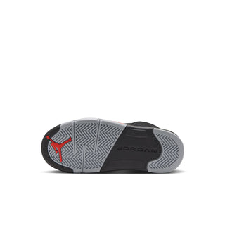 Black kids sneakers with gray outsole tread; red Jumpman logo and JORDAN text on sole