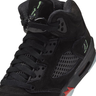 Black youth Air Jordan 5 sneaker close-up with lace eyelets and Jumpman tongue