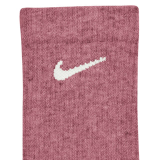 Ribbed crew sock close-up in dusty pink with white Nike swoosh