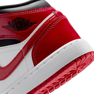 Close-up of youth sneakers: red leather quarter with stitched seams and Air Jordan logo