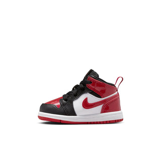 Kids mid-top sneakers side view in black, red, and white with Nike Swoosh
