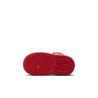 Kids mid-top sneakers outsole view with red tread and circular traction pattern