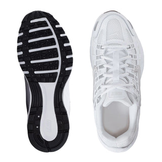 Shoe outsole and side view: black tread with white upper, lace-up design