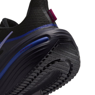 Women’s black outsole tread with blue accent groove and purple pull-tab detail