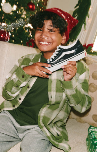 Teenager posing with Vans shoes