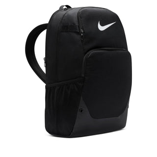 Nike Brasilia backpack side view, black body with white logo and adjustable shoulder straps.