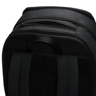 Nike Brasilia backpack top close-up showing multiple zip compartments and carry handle.