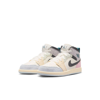 Kids Air Jordan 1 mid-top sneakers, cream uppers with black swoosh and pink hits.