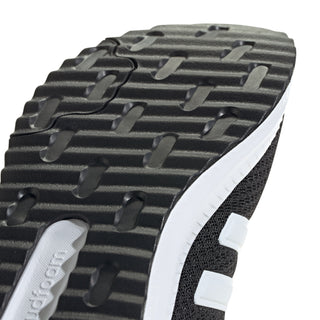 Close-up of men's black tread outsole and textured grip pattern with white edge trim