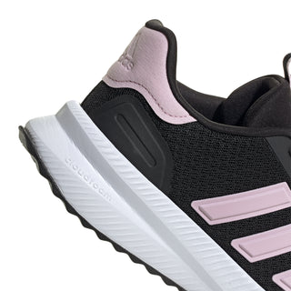 Women's black sneaker side view with pink heel tab and ridged white midsole, adidas stripes