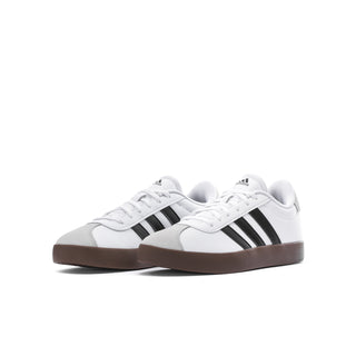 Youth adidas sneakers, front view with white upper, black three stripes, gum outsole