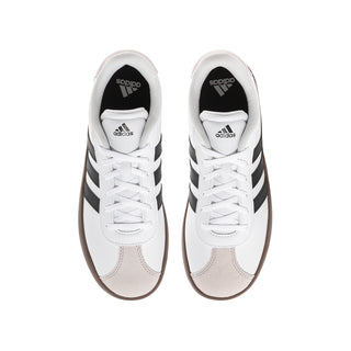 Youth adidas sneakers pair, white laces, black stripes, brown gum toe and heel