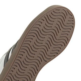 Youth adidas sneaker outsole close-up, brown wavy tread pattern