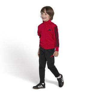 Kids black-and-white sneakers with brown soles on a child