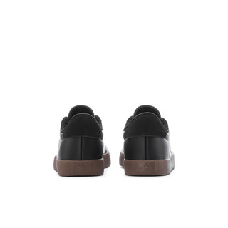 Youth black adidas sneaker heel with strap tab and gum-brown back sole