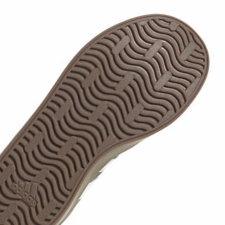 Youth sneaker outsole close-up with wavy tread in brown