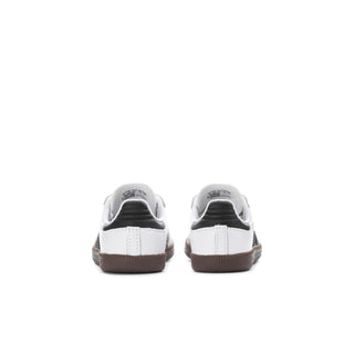 Toddler sneakers with white uppers, black heel lining, and gum brown sole