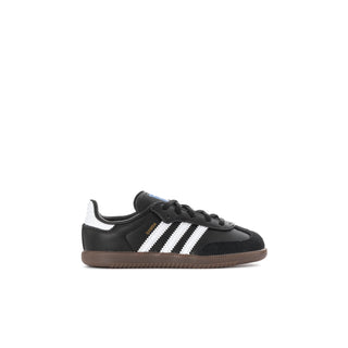 Kids’ black and white sneakers with three stripe detailing and gum sole